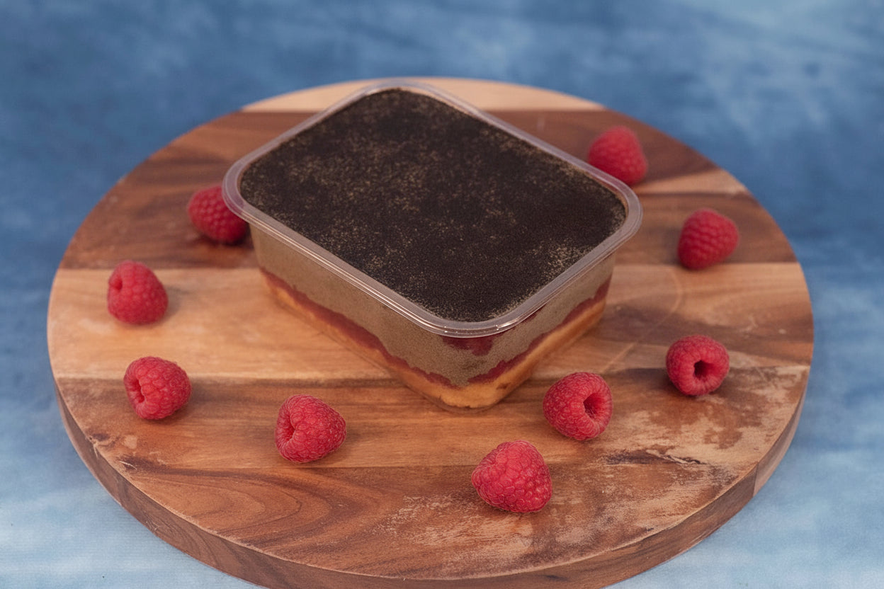 Keto strawberry hojicha box cake dessert on a wooden platter with organic strawberries.