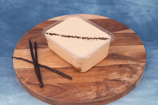 Keto London Fog box cake dessert made with Earl Grey tea, served on a wooden platter with vanilla bean garnish.